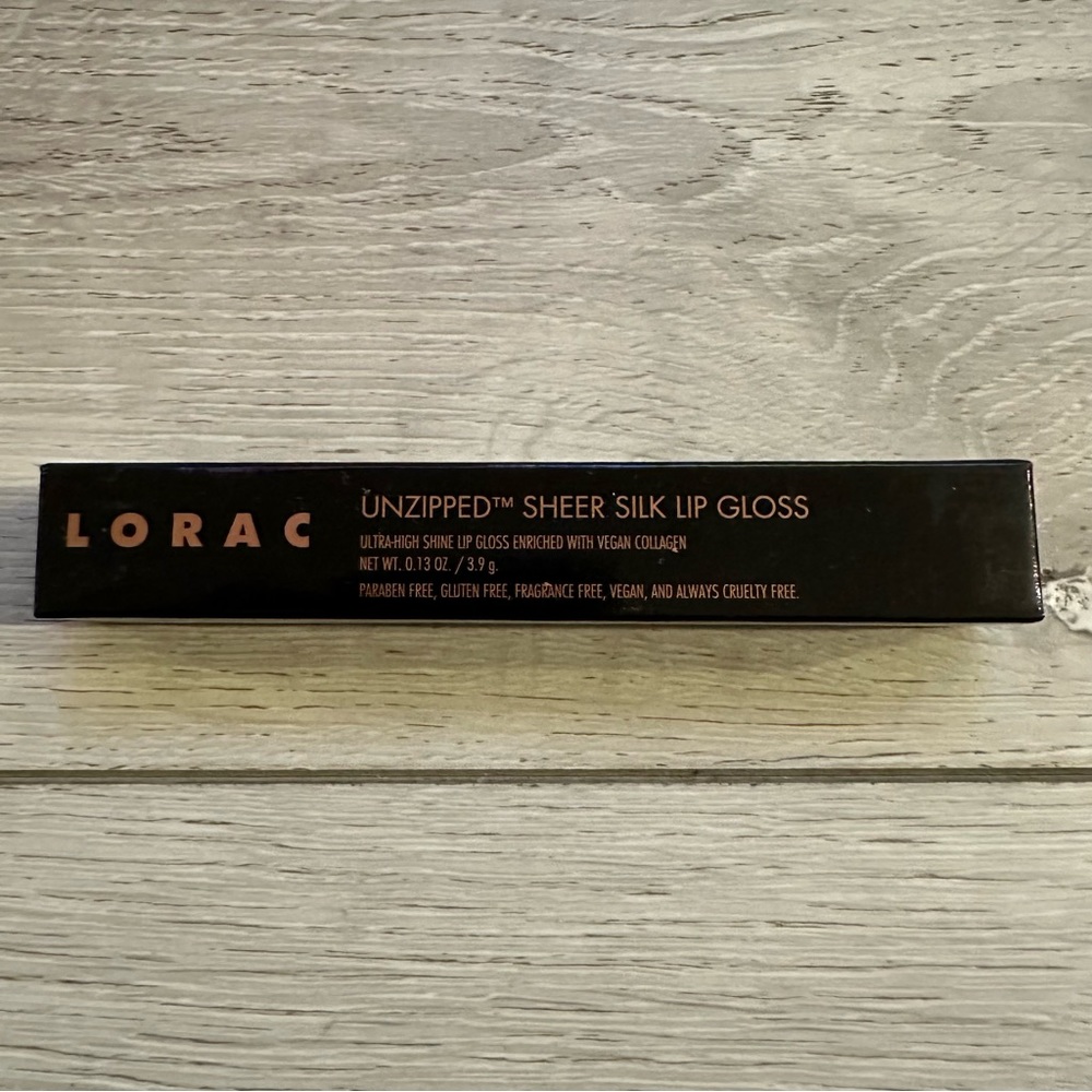 New in Box Lorac Unzipped Sheer Silk Lip Gloss in color Exposed pink red coral
